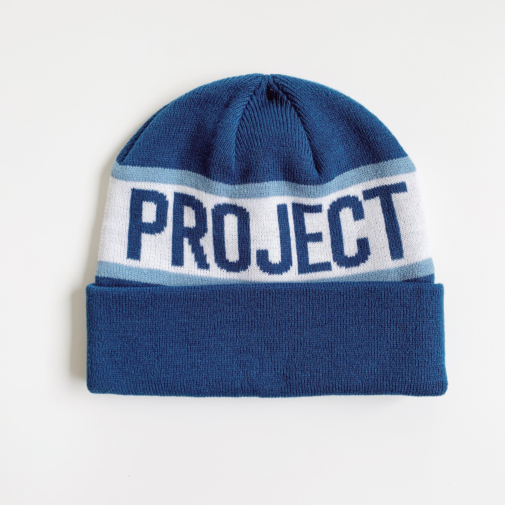 Navy Non-GMO Project beanie other side  with  phrase "PROJECT" 