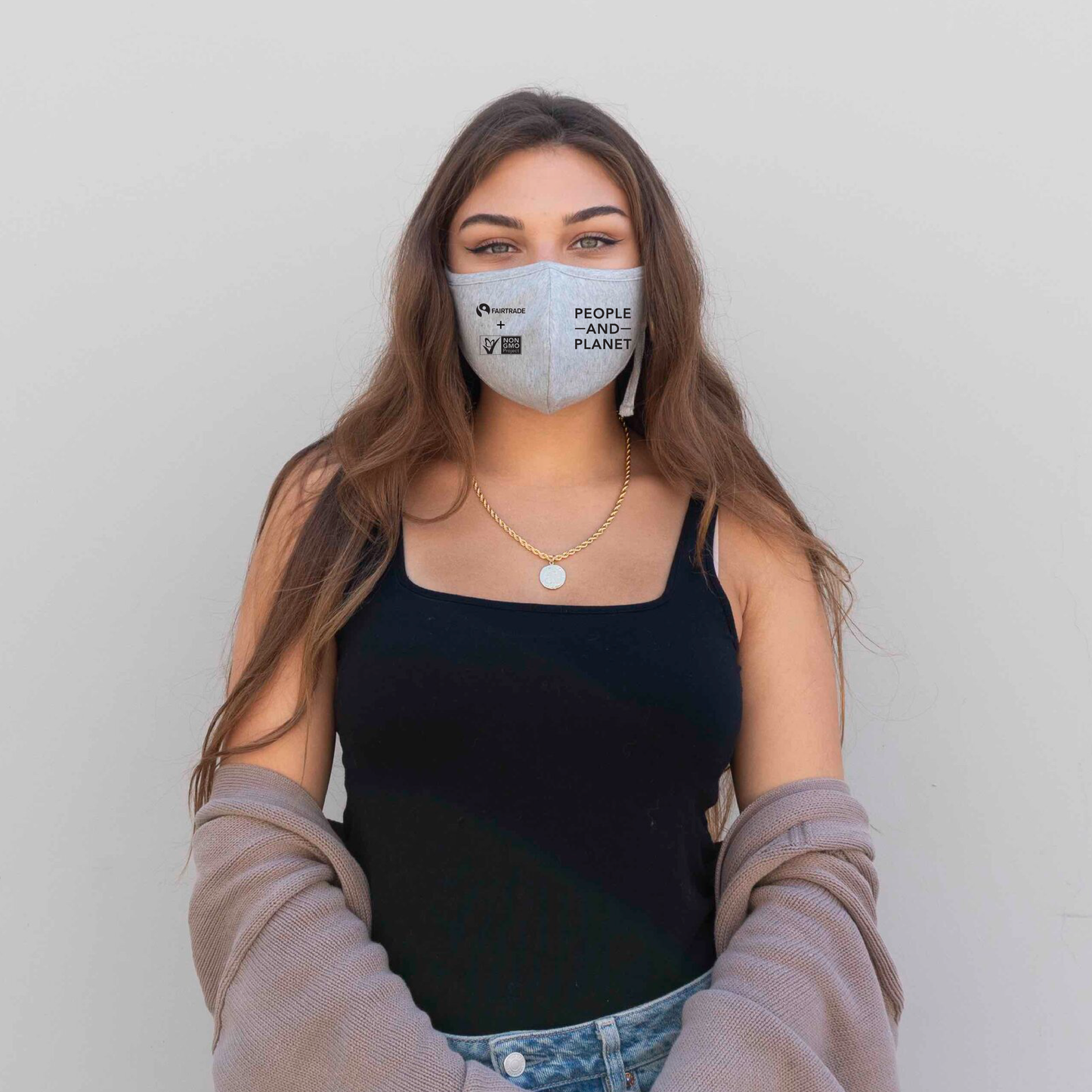 Woman facing camera wearing  Non-GMO Project face mask